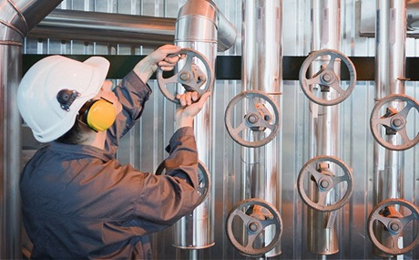 Engineer adjusting valve