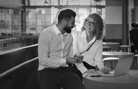 Two professionals conversing casually. Two professionals conversing casually.